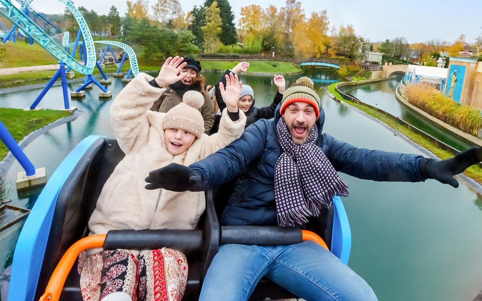 Family on a roller coaster at Parc Astérix, France, experiencing thrilling ride.