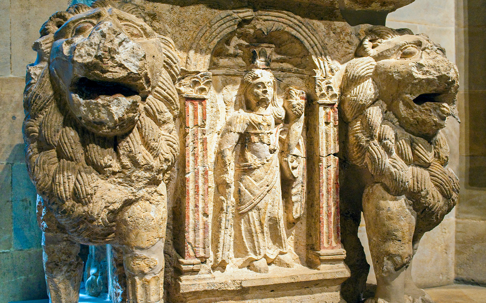 Ancient stone relief with lions and a figure in Beirut museum.
