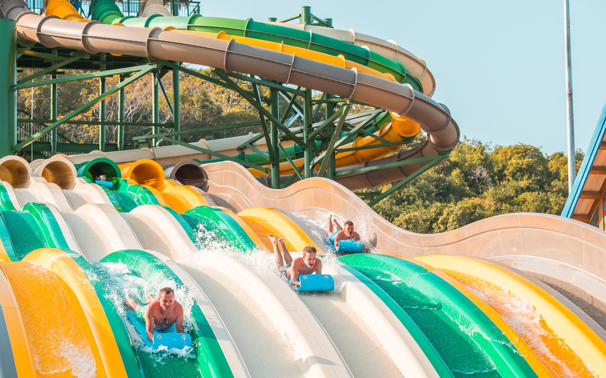 Water slides at Aquatopia Water Park, Hon Thom Island, with people enjoying the ride.