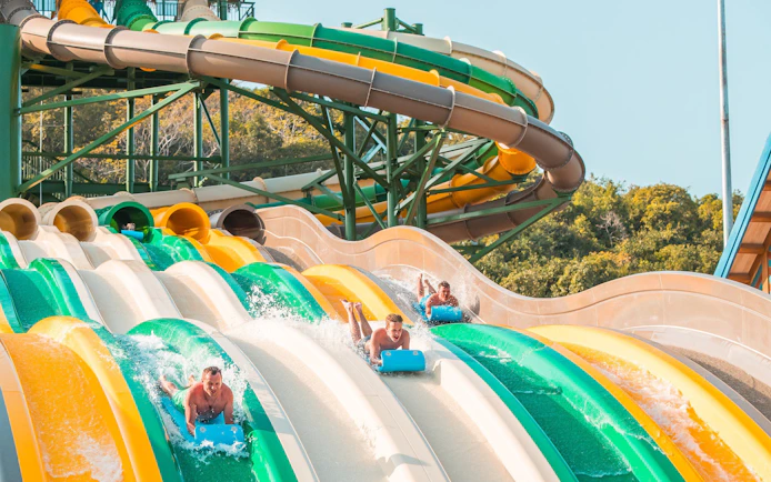 Water slides at Aquatopia Water Park, Hon Thom Island, with people enjoying the ride.
