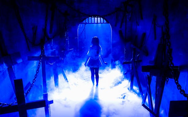 Silhouette of a person in a misty, cross-filled hallway on The Conjuring Universe Tour in Thailand.