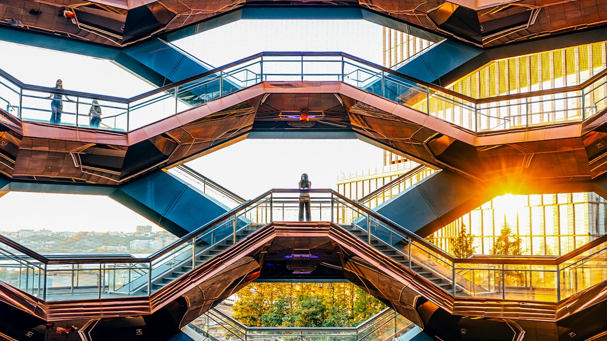 Vessel structure in New York City with visitors exploring the honeycomb design.