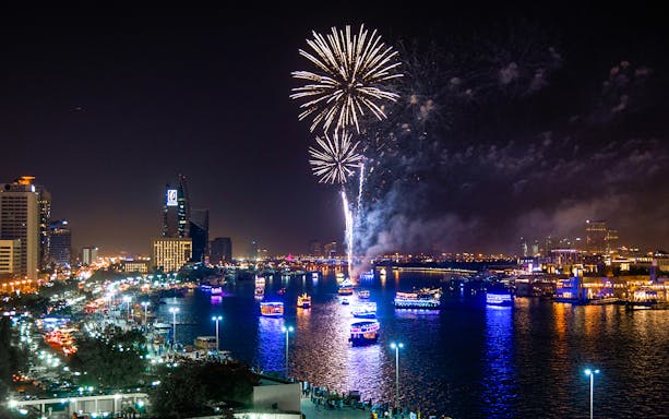 Fireworks over Dubai Marina during New Year Eve speedboat tour with Burj Al Arab in view.