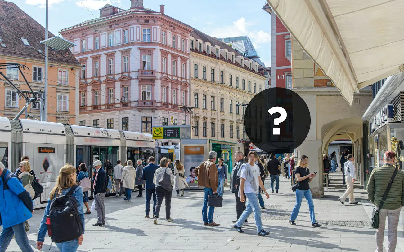 Pedestrians and tram in Graz city center during self-guided exploration game.