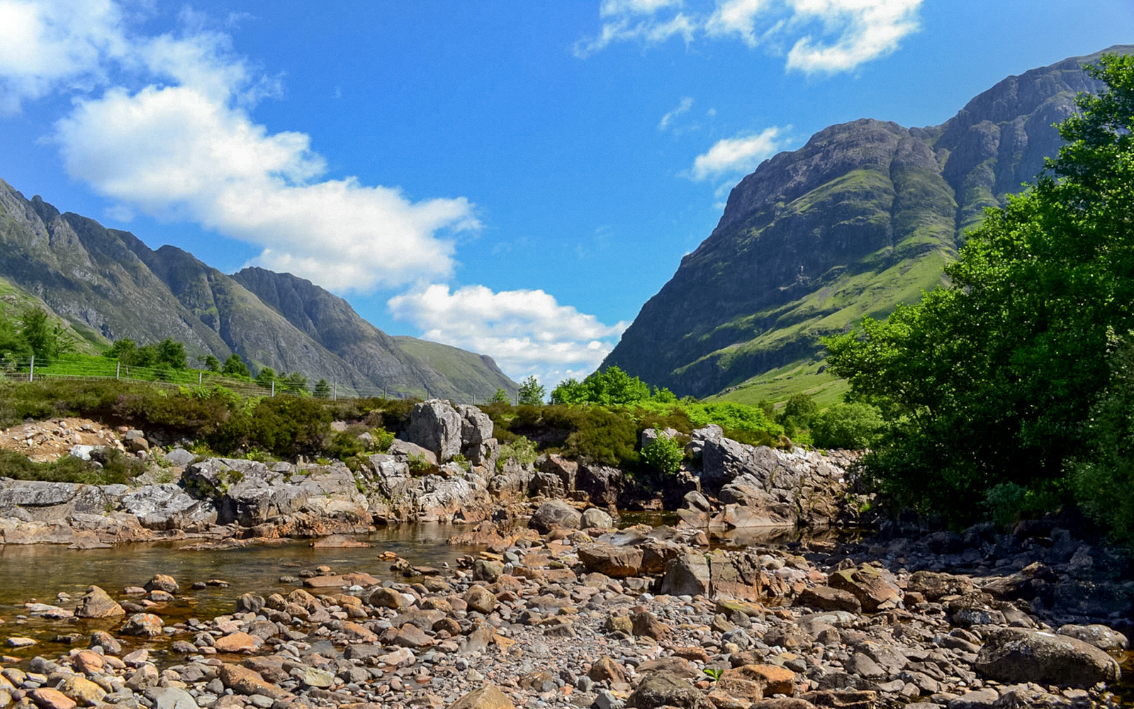 Glenfinnan and Glencoe mountains with rocky stream, part of Fort William tour from Edinburgh.