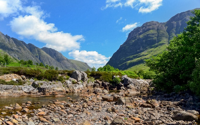 Glenfinnan and Glencoe mountains with rocky stream, part of Fort William tour from Edinburgh.