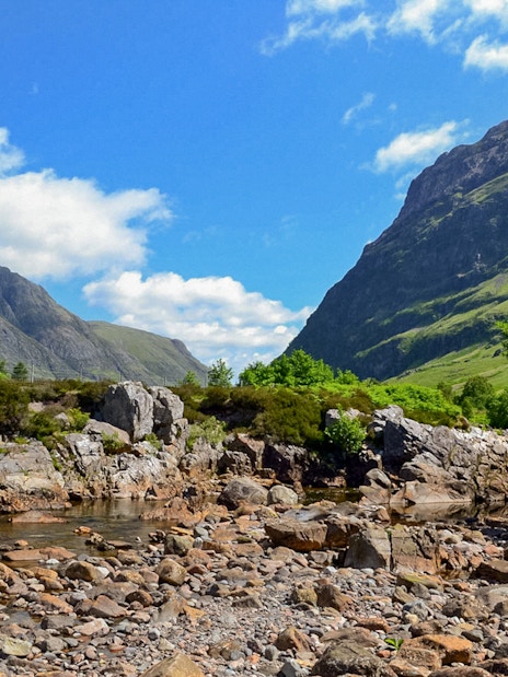 Glenfinnan and Glencoe mountains with rocky stream, part of Fort William tour from Edinburgh.