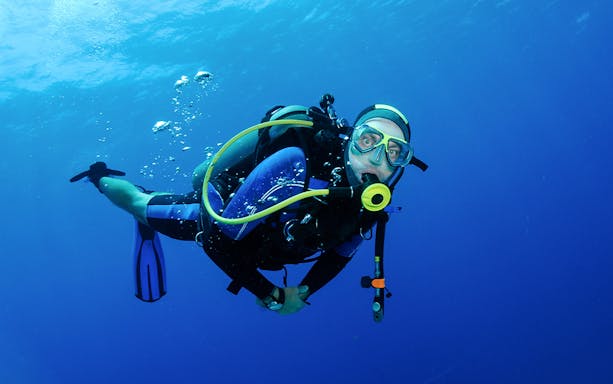 Scuba diver exploring underwater in Tanjung Benoa, Bali.