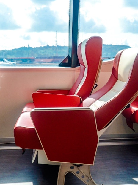 Ferry seats with red upholstery on the Singapore to Bintan route.