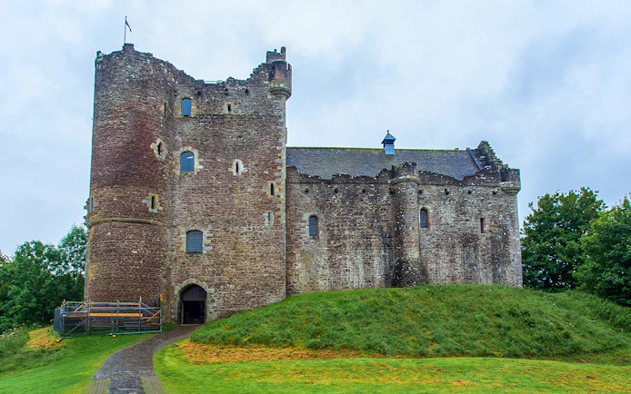 Stirling Castle in Scotland with stone walls and green landscape.