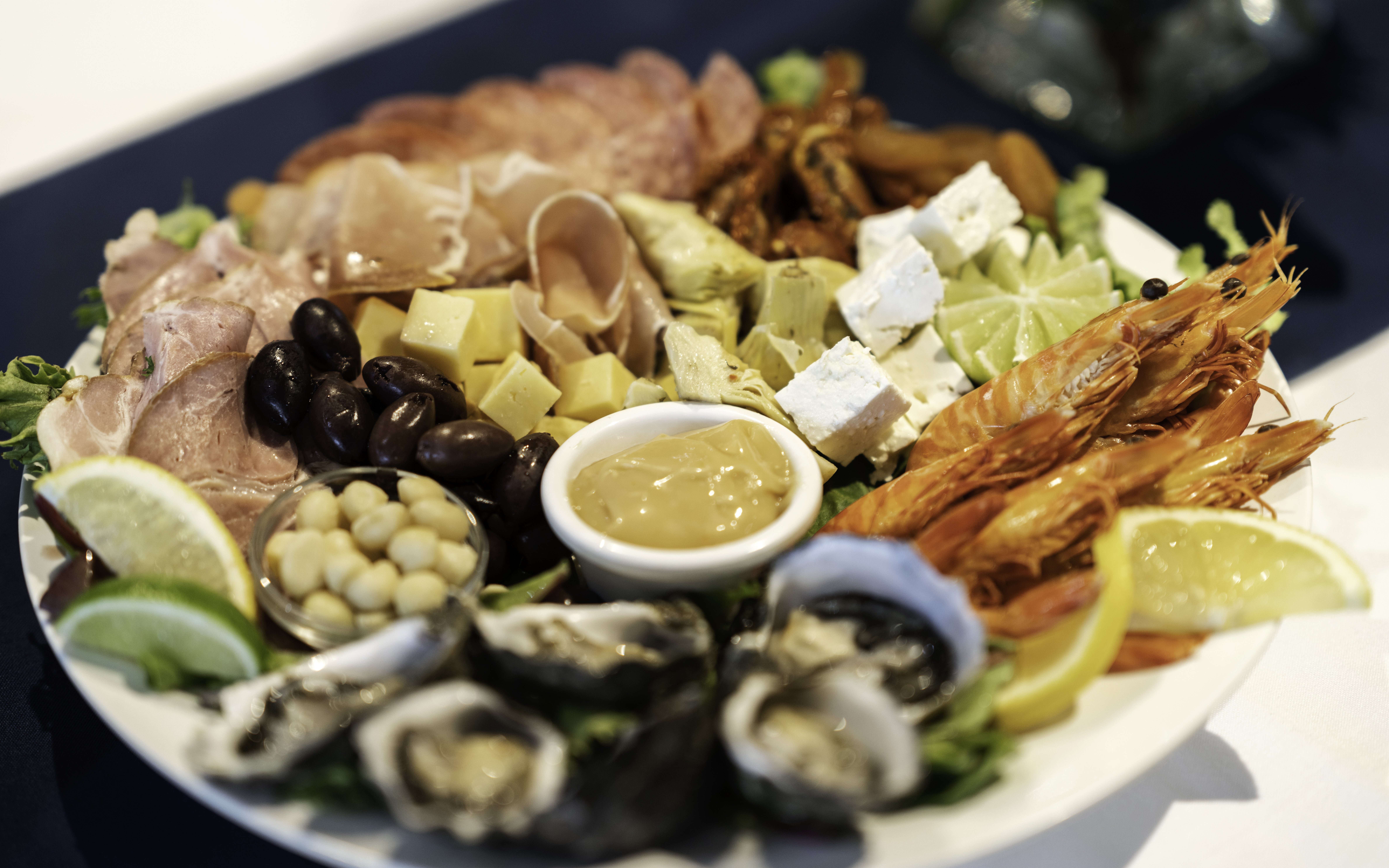 Seafood platter with prawns, oysters, cheese, and olives on Darwin Harbour Sunset Dinner Cruise.