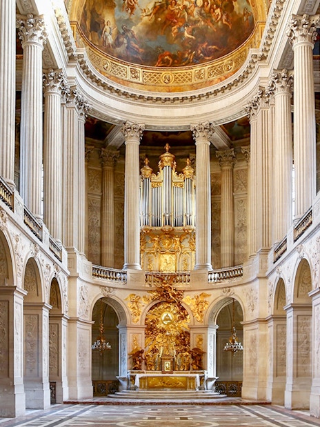 Royal Chapel interior with ornate columns and grand organ, Palace of Versailles.