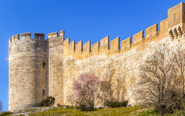 Fort Saint-André stone walls and tower under clear blue sky.