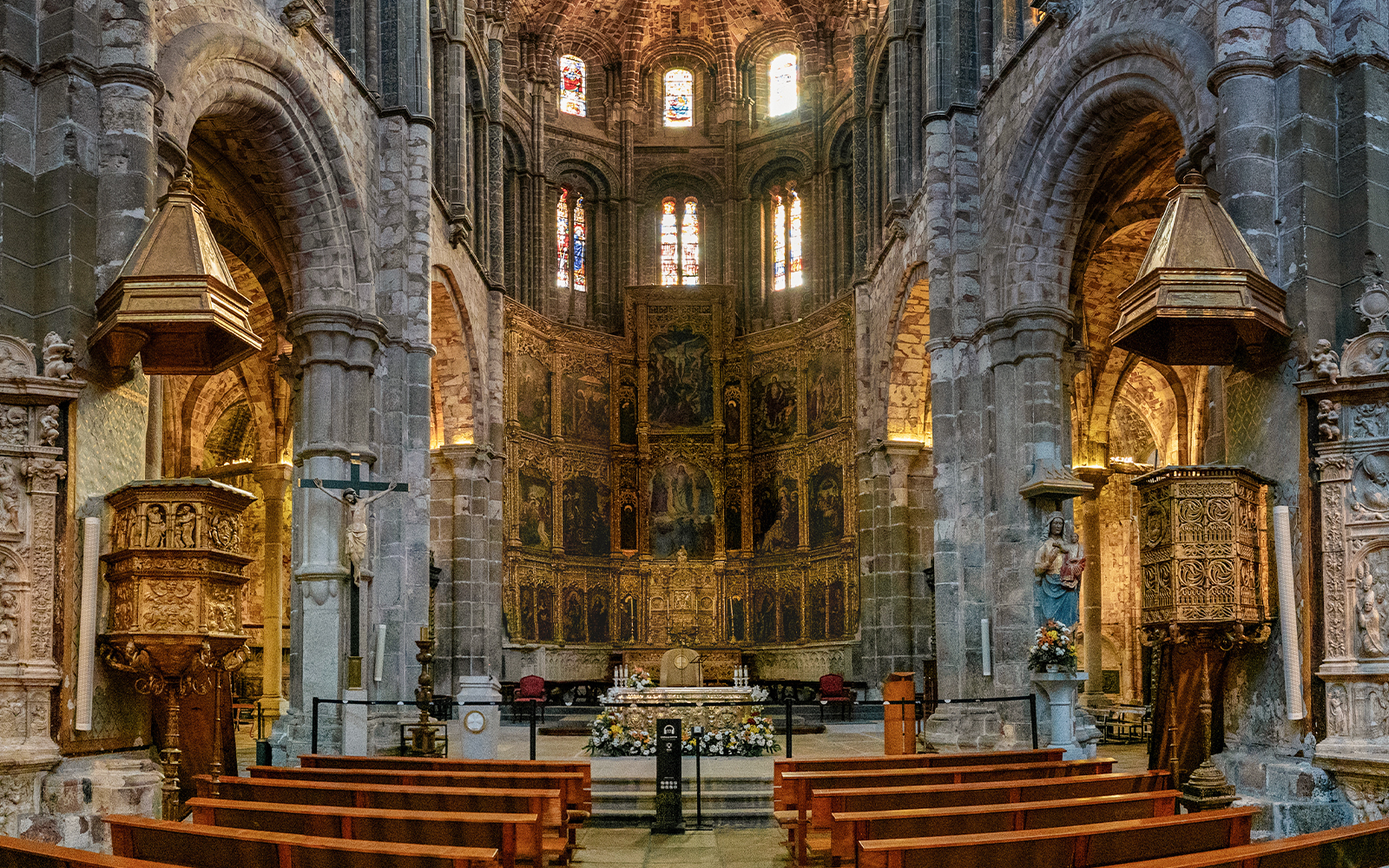 Central nave and gilded altarpiece in Avila Cathedral, Spain.