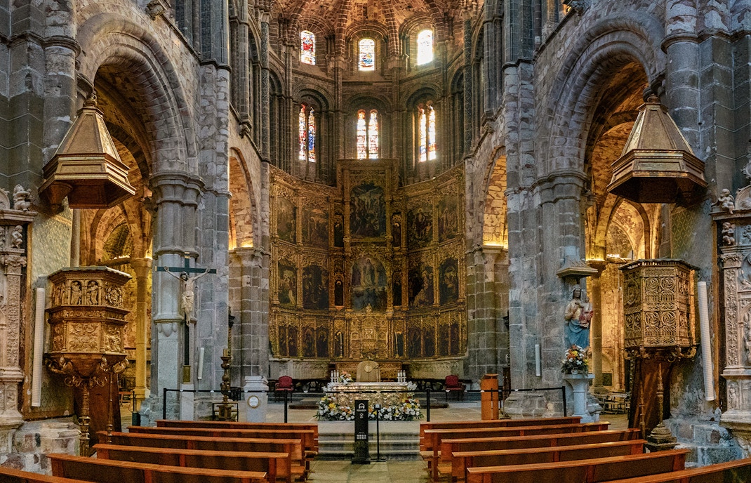 Central nave and gilded altarpiece in Avila Cathedral, Spain.