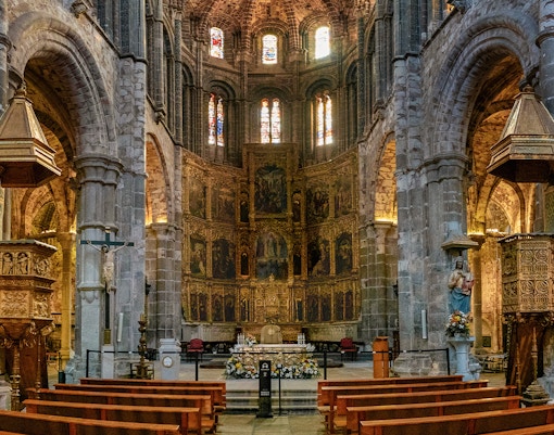 Central nave and gilded altarpiece in Avila Cathedral, Spain.