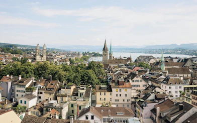 Panoramic view of Zurich's old town with historic churches and Lake Zurich in the background.