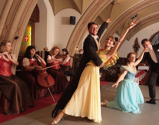 Performers waltzing on stage.