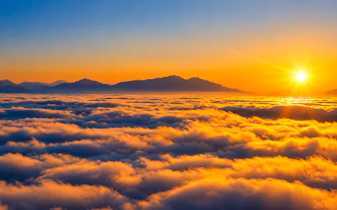 Sunrise over clouds with distant mountains, Nagarkot Sunrise Tour, Nepal.