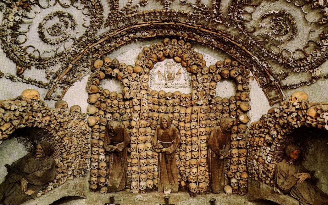 Capuchin Crypt adorned with skulls and bones in Rome Catacombs.