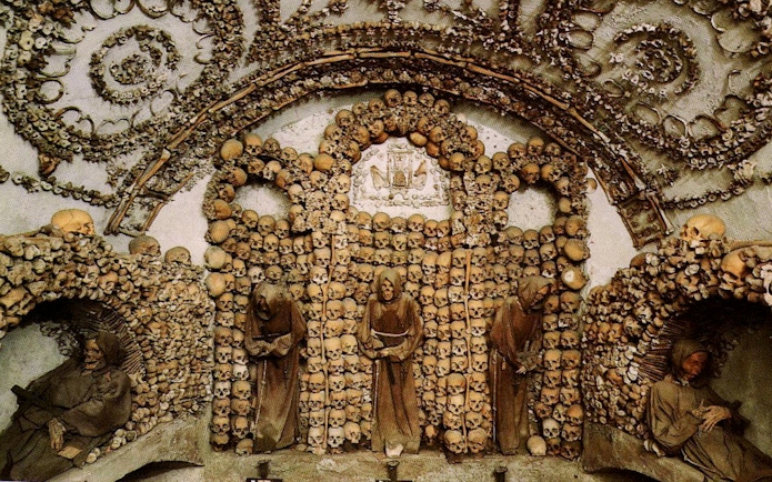 Capuchin Crypt adorned with skulls and bones in Rome Catacombs.