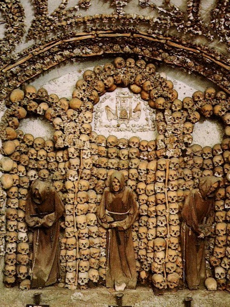 Capuchin Crypt adorned with skulls and bones in Rome Catacombs.