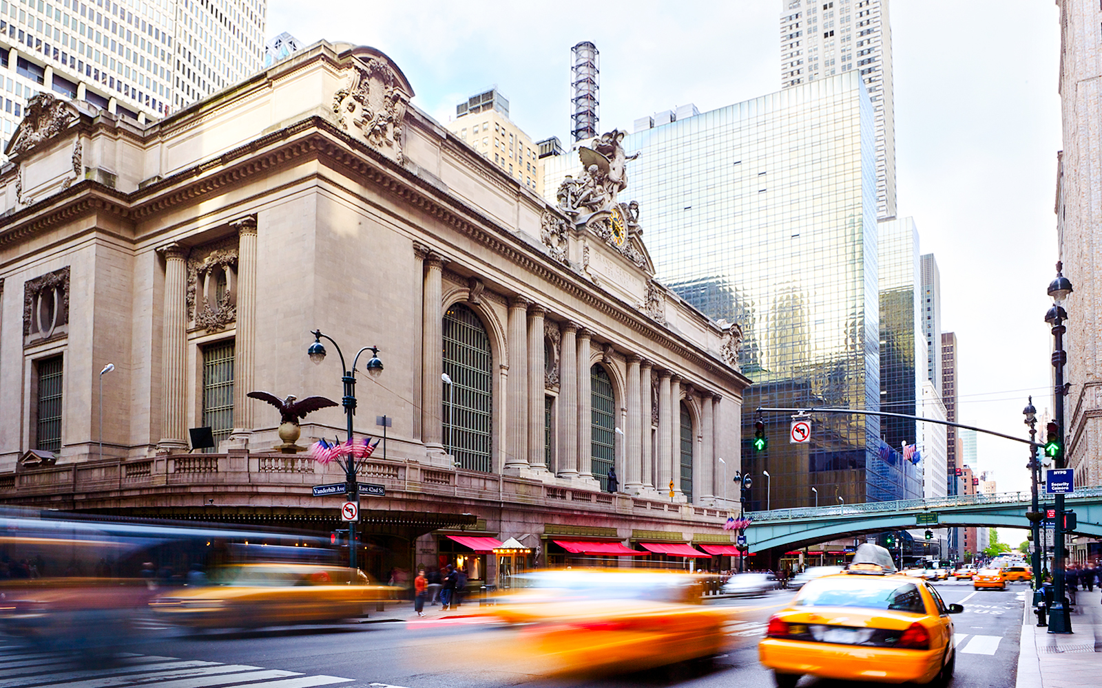 Grand Central Terminal with yellow taxis and traffic in New York City.
