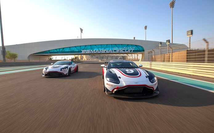 Aston Martin GT4 cars racing at Yas Marina Circuit in Abu Dhabi.