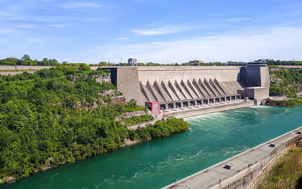 Robert Moses Power Station with flowing river, surrounded by greenery, Canada.