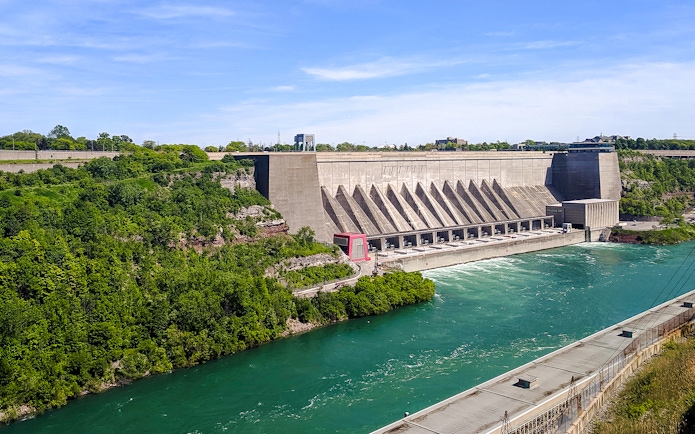 Robert Moses Power Station with flowing river, surrounded by greenery, Canada.