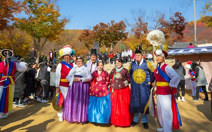 Visitors in traditional Korean attire at Korean Folk Village near Seoul.