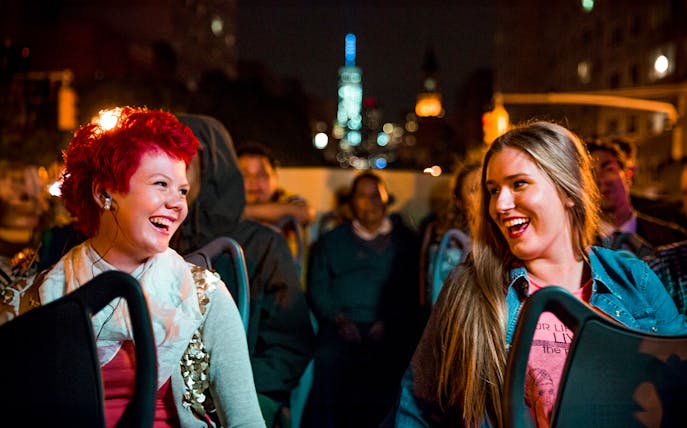 Tourists enjoying Big Bus Los Angeles Holiday Lights Tour at night.