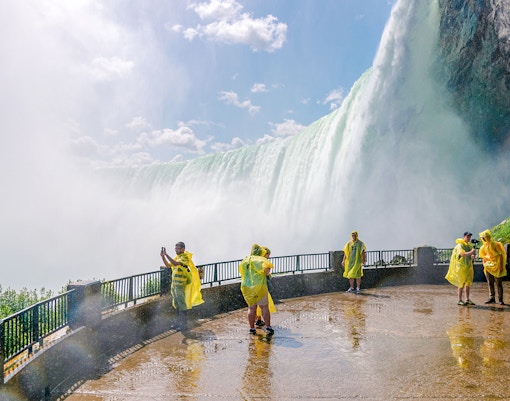Visitors exploring Niagara Falls, experiencing the powerful cascade up close.
