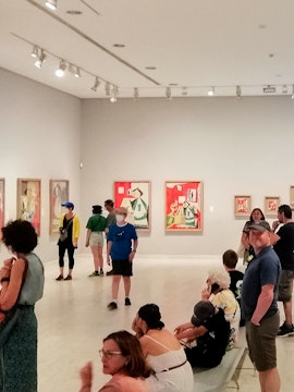 Visitors viewing artwork inside Picasso Museum, Barcelona.