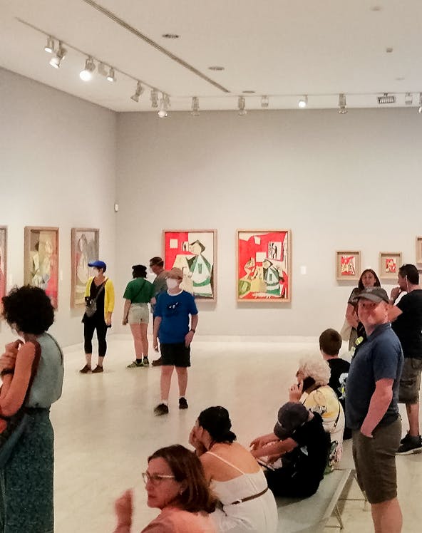 Visitors viewing artwork inside Picasso Museum, Barcelona.