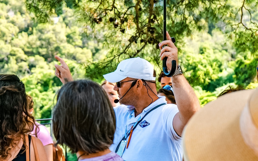 Tour guide giving directions to a group at Krka National Park.