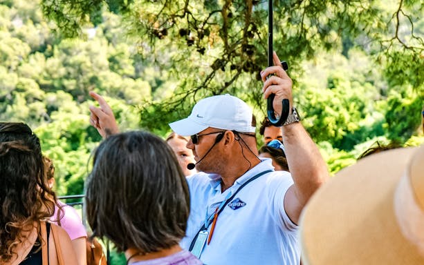 Tour guide giving directions to a group at Krka National Park.