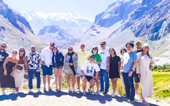 Group of tourists at Cajón del Maipo with Andes mountains in the background, Santiago, Chile.