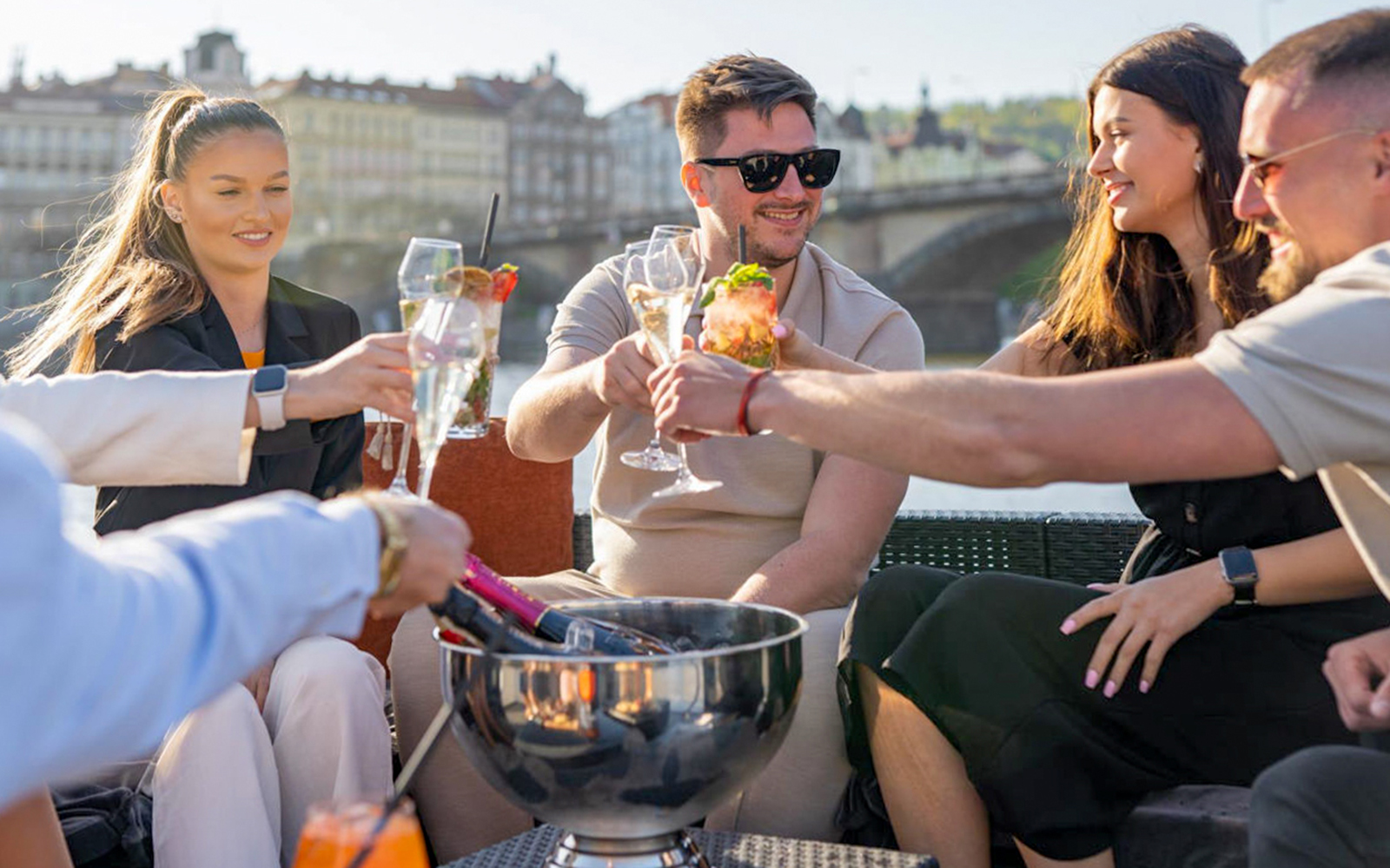 Group enjoying drinks on a Prague yacht cruise with unlimited beer or prosecco.