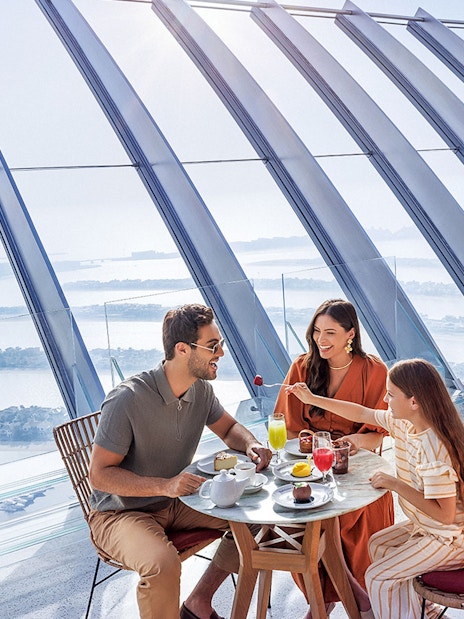 Family dining with a view of Palm Jumeirah at The View At The Palm, Dubai.