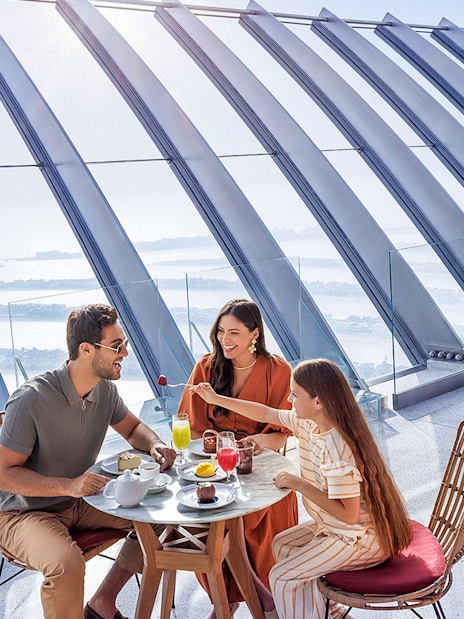 Family dining with a view of Palm Jumeirah at The View At The Palm, Dubai.