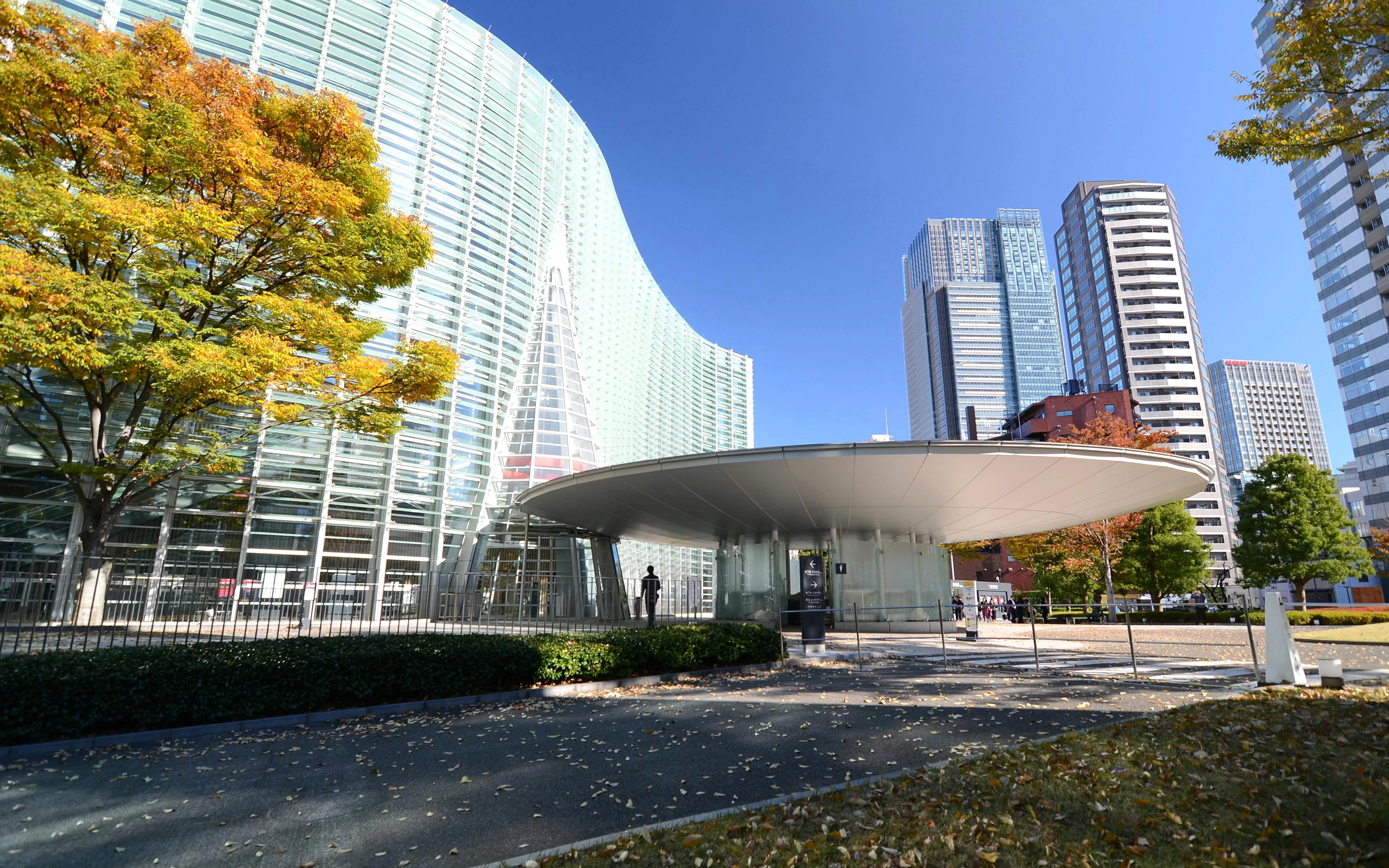 National Art Center Tokyo exterior with modern glass architecture and surrounding skyscrapers.