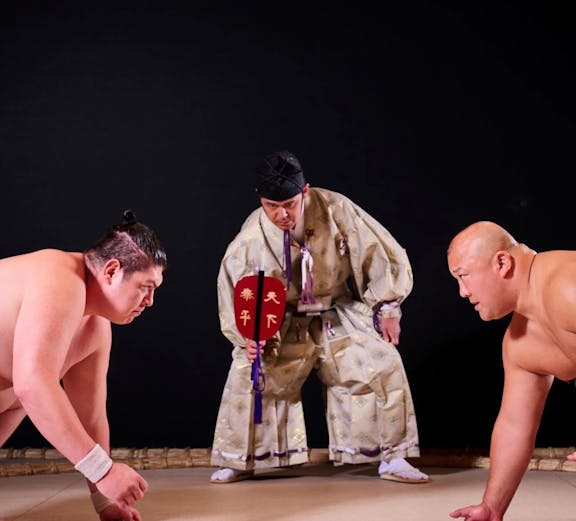 Sumo wrestlers prepare to compete at Hirakuza Ginza, Tokyo.
