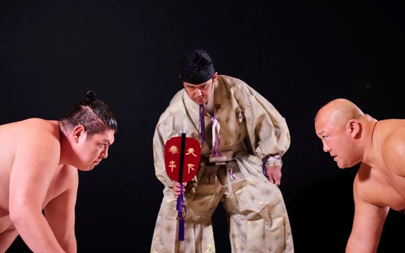 Sumo wrestlers prepare to compete at Hirakuza Ginza, Tokyo.