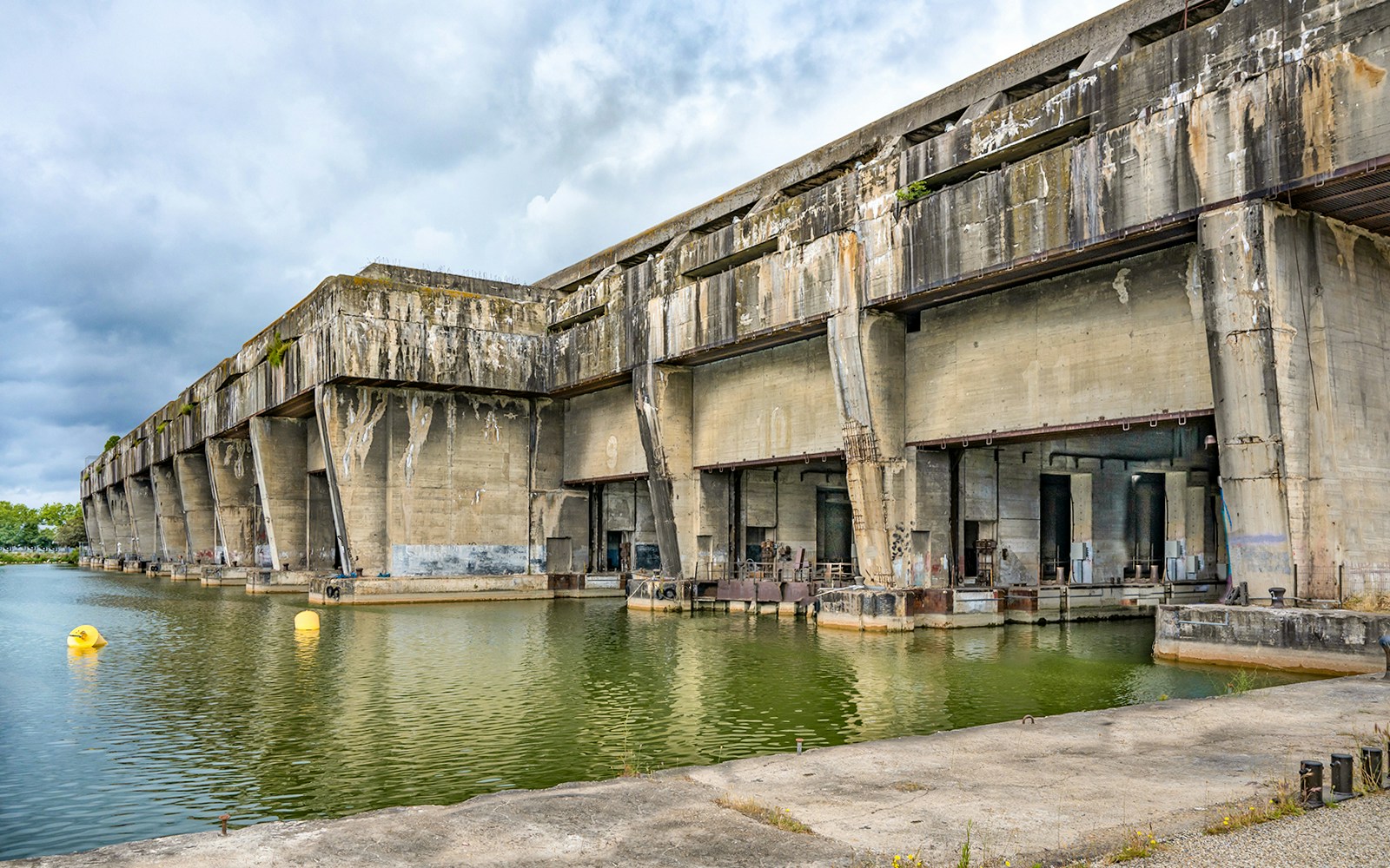 World War 2 German U-boat base in Bordeaux with concrete structure and water.
