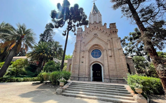 Santa Rita Vineyard chapel surrounded by lush greenery, Santiago.