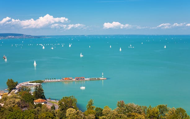 Sailboats on Lake Balaton with Tihany Peninsula in the distance, Hungary.