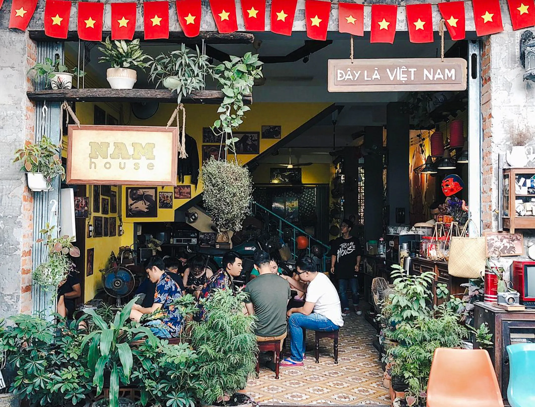 Hidden cafe in Da Nang with people enjoying drinks and conversation, part of the Sunset Hidden Cafes Tour.