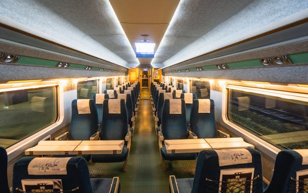 Interior of a KTX train in Korea with rows of empty seats, part of the KR Pass Ticket experience.