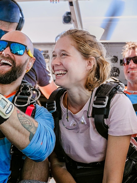 Skydivers smiling inside plane before tandem jump, Rottnest Island.